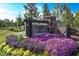 Community entrance sign surrounded by colorful flowers and greenery, creating a welcoming atmosphere at 7 Hickory Branch, Hiram, GA 30141