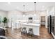 Bright, modern kitchen with a center island, stainless appliances, and stylish stools at 7 Hickory Branch, Hiram, GA 30141