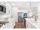 Bright kitchen featuring white cabinets, stainless steel appliances, and a stylish faucet at 7 Hickory Branch, Hiram, GA 30141