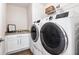 Convenient laundry room with modern washer and dryer units and storage cabinets at 7 Hickory Branch, Hiram, GA 30141