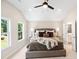 Bright bedroom with a vaulted ceiling, large windows, and an ensuite bathroom at 7 Hickory Branch, Hiram, GA 30141
