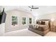 Spacious main bedroom featuring three large windows with natural light and ceiling fan at 7 Hickory Branch, Hiram, GA 30141