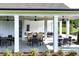 An outdoor patio with multiple tables and chairs, perfect for entertaining or enjoying a meal al fresco at 7 Hickory Branch, Hiram, GA 30141