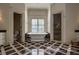 Elegant bathroom with a soaking tub, marble floors, and and sinks at 1691 Doncaster Ne Dr, Atlanta, GA 30309