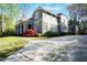 Attractive home featuring a long driveway, beautiful landscaping, and lovely trees at 1691 Doncaster Ne Dr, Atlanta, GA 30309