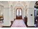 Elegant entryway featuring arched doorways, paneled columns, and a decorative rug at 1691 Doncaster Ne Dr, Atlanta, GA 30309