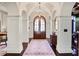 Grand foyer featuring arched doorways, hardwood floors, and elegant lighting fixtures at 1691 Doncaster Ne Dr, Atlanta, GA 30309