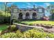Charming gray home with stone arches and lush landscaping in a desirable neighborhood at 1691 Doncaster Ne Dr, Atlanta, GA 30309