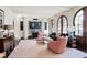 Warm and inviting living room with a stone fireplace and large arched windows at 1691 Doncaster Ne Dr, Atlanta, GA 30309