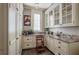 Walk-in pantry with custom cabinets, granite countertops, and a sink for added convenience at 1691 Doncaster Ne Dr, Atlanta, GA 30309