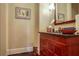 Elegant powder room features a wooden vanity with granite countertop and stylish fixtures at 1691 Doncaster Ne Dr, Atlanta, GA 30309