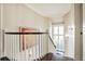 Staircase featuring hardwood steps, white railing, and a decorative painting at 1691 Doncaster Ne Dr, Atlanta, GA 30309