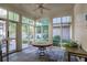 Light-filled sunroom with tiled floors, multiple windows, and access to outdoor patio at 1691 Doncaster Ne Dr, Atlanta, GA 30309