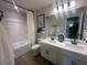 Well-lit bathroom with a double sink vanity, modern fixtures, and a shower-tub combo at 4574 Eastbrook Pl, Snellville, GA 30039