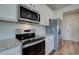 Modern kitchen with granite counters, stainless appliances, white cabinets, and subway tile backsplash at 4574 Eastbrook Pl, Snellville, GA 30039