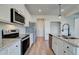 Kitchen includes stainless steel appliances, granite countertops, white cabinets, and a tile backsplash at 4574 Eastbrook Pl, Snellville, GA 30039