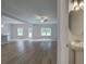 Bright, open-concept living room with hardwood floors, ceiling fan, and natural light from the exterior windows at 4574 Eastbrook Pl, Snellville, GA 30039