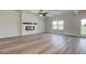 Spacious living room features an electric fireplace, tray ceiling, and wood-look floors at 4574 Eastbrook Pl, Snellville, GA 30039