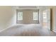 Spacious carpeted main bedroom with ample natural light and a doorway to the ensuite bathroom at 4574 Eastbrook Pl, Snellville, GA 30039