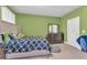 Bedroom featuring green walls, carpeted floors, and a queen sized bed with a navy blue duvet at 80 Lanier Rdg, Acworth, GA 30101