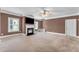 Spacious living room with carpet, a fireplace, a ceiling fan, and natural light from windows at 80 Lanier Rdg, Acworth, GA 30101