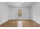 Spacious bedroom features gleaming hardwood floors, a ceiling fan, and a large window at 869 Briarcliff Ne Rd # B11, Atlanta, GA 30306