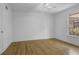 Bright bedroom features gleaming hardwood floors, a ceiling fan, and a large window at 869 Briarcliff Ne Rd # B11, Atlanta, GA 30306