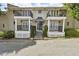 Charming two-story townhouse featuring classic architecture with a front porch and black wrought iron balcony at 869 Briarcliff Ne Rd # B11, Atlanta, GA 30306