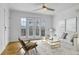 Bright living room features hardwood floors, ceiling fan, and French doors to the balcony at 869 Briarcliff Ne Rd # B11, Atlanta, GA 30306