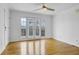 Bright living room features hardwood floors, ceiling fan, and French doors to the balcony at 869 Briarcliff Ne Rd # B11, Atlanta, GA 30306