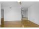 Living room featuring gleaming hardwood floors and leading into the kitchen at 869 Briarcliff Ne Rd # B11, Atlanta, GA 30306