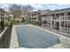 Community pool covered for the off-season, surrounded by fencing and neighboring townhouses at 869 Briarcliff Ne Rd # B11, Atlanta, GA 30306