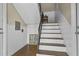 Staircase features hardwood steps, a decorative handrail, and neutral walls at 869 Briarcliff Ne Rd # B11, Atlanta, GA 30306