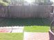 Fenced backyard featuring a small brick patio, a section of lush grass, and a bright sunny view at 105 Governors Dr, Forest Park, GA 30297