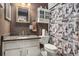 Quaint bathroom features an intricate shower curtain, framed mirror, and cabinet storage at 105 Governors Dr, Forest Park, GA 30297