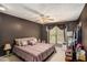 Relaxing bedroom with a ceiling fan, soft lighting, and a window view at 105 Governors Dr, Forest Park, GA 30297