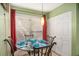 Bright dining area with a glass table, red accents, and ample natural light at 105 Governors Dr, Forest Park, GA 30297