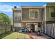 Back of house showing a patio, gray siding, yard, and mature trees at 105 Governors Dr, Forest Park, GA 30297