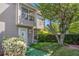 Inviting townhome with neat lawn, blossoming bush, and secure ADT system at 105 Governors Dr, Forest Park, GA 30297