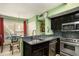Stylish kitchen with granite countertops, stainless steel appliances, and adjacent dining space at 105 Governors Dr, Forest Park, GA 30297
