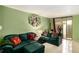 Inviting living room with plush green seating and plenty of natural light at 105 Governors Dr, Forest Park, GA 30297
