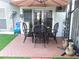 Outdoor patio area with brick pavers, table and chairs, and a large umbrella for shade at 105 Governors Dr, Forest Park, GA 30297