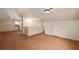 A spacious attic room with neutral carpet, white walls, and natural light from a window, offering storage or flexible living space at 51 Willow Wood Se Cir, Atlanta, GA 30317
