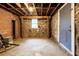 Unfinished basement with stone walls, wood support beams, and concrete floor, offering lots of extra storage space at 51 Willow Wood Se Cir, Atlanta, GA 30317