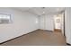 Unfinished basement space with white walls, concrete floor, window, and doorway to a finished bathroom at 51 Willow Wood Se Cir, Atlanta, GA 30317