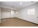 Unfinished basement with concrete floor, white walls, and a window, offering a blank canvas for a workshop or storage at 51 Willow Wood Se Cir, Atlanta, GA 30317