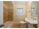Well-lit bathroom with tiled shower, tile flooring, pedestal sink and window at 51 Willow Wood Se Cir, Atlanta, GA 30317
