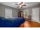 Comfortable bedroom with hardwood floors, ceiling fan, and two windows for natural light at 51 Willow Wood Se Cir, Atlanta, GA 30317