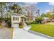 Charming home featuring a well-manicured lawn, inviting front porch, and convenient garage at 51 Willow Wood Se Cir, Atlanta, GA 30317