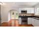 Well-lit kitchen with stainless steel appliances, granite countertops, and hardwood flooring at 51 Willow Wood Se Cir, Atlanta, GA 30317